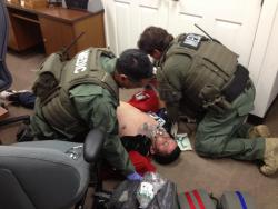 ATF medics treat an injured suspect during a special response team arrest operation